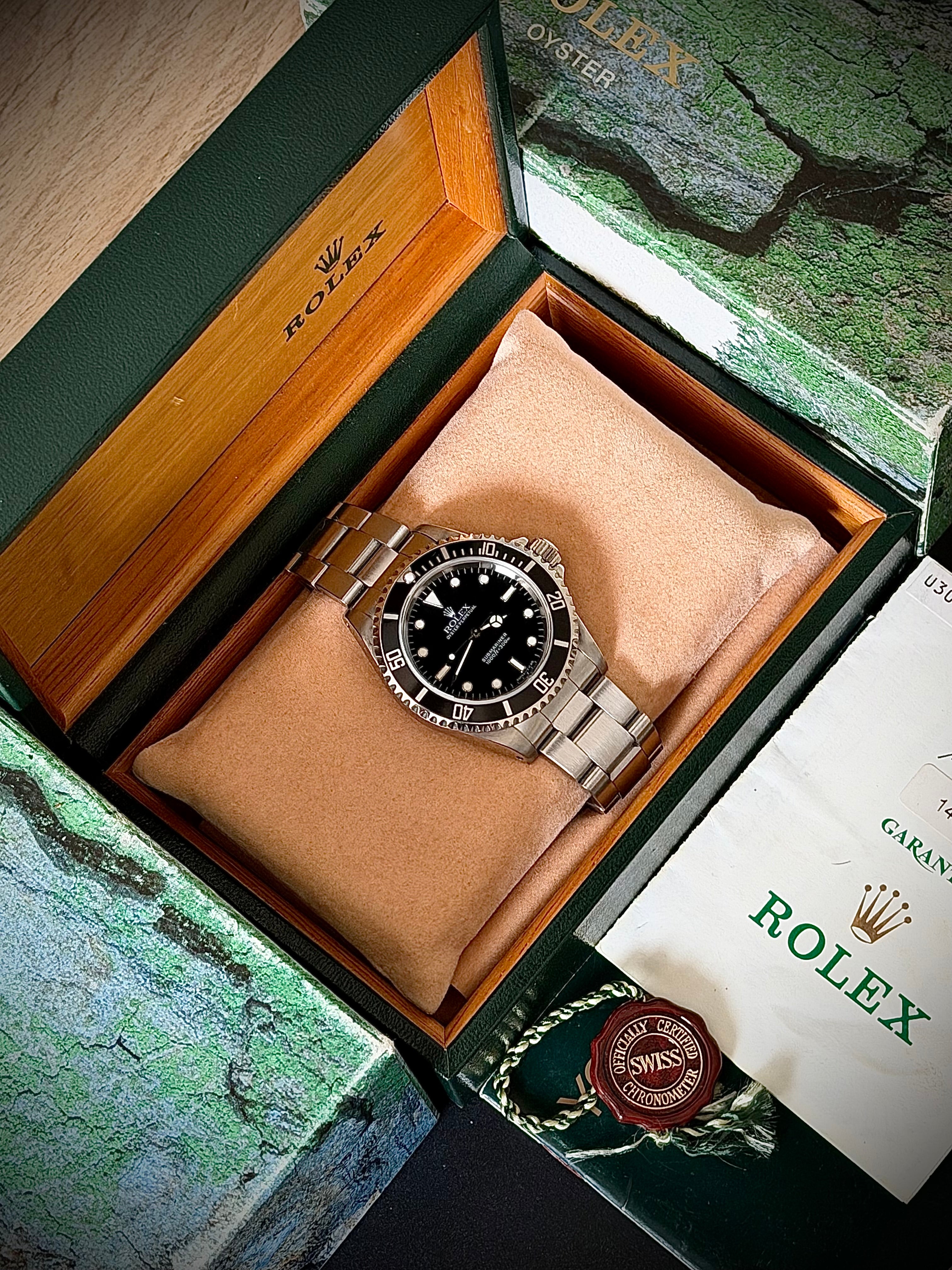 1997 ROLEX SUBMARINER NO-DATE, TWO LINER, 14060, BOX AND PAPERS, INC GST