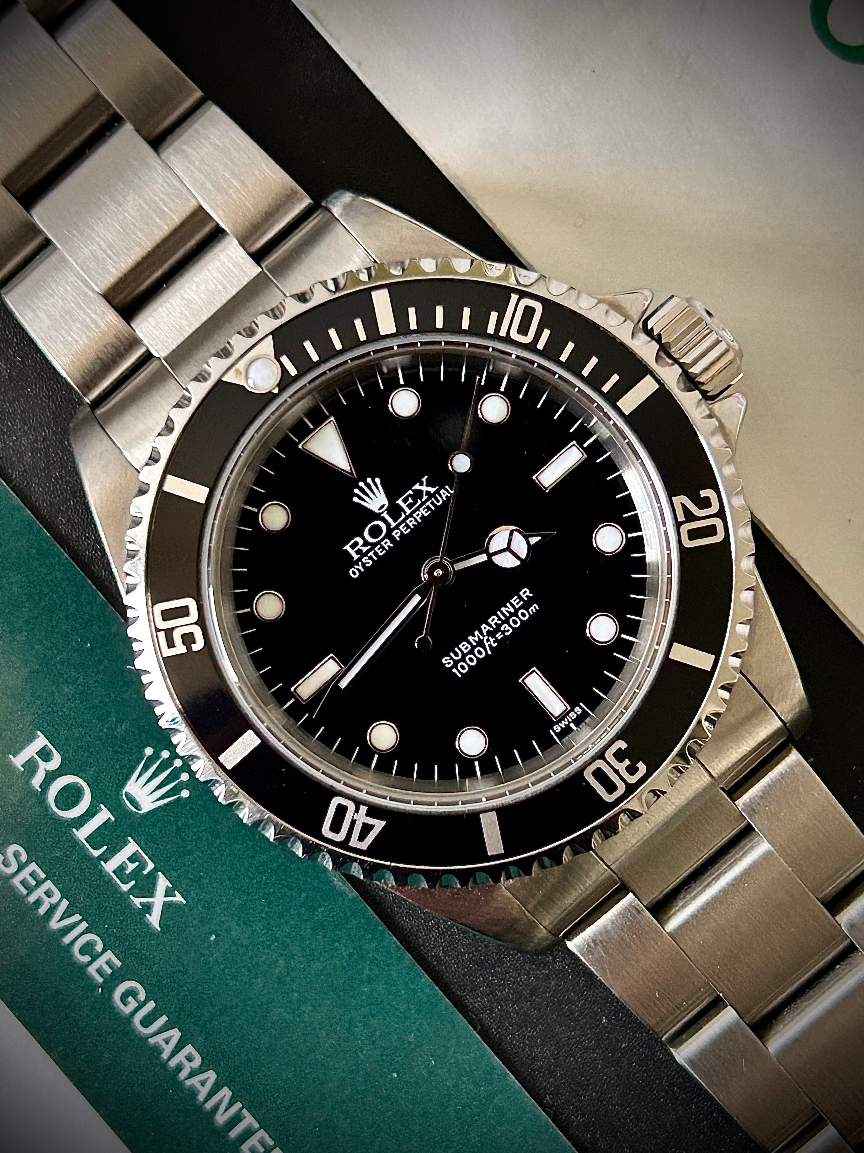 1999 ROLEX SUBMARINER NO-DATE, TWO LINER, SWISS ONLY, 14060, BOX AND PAPERS WITH RSC, INC GST