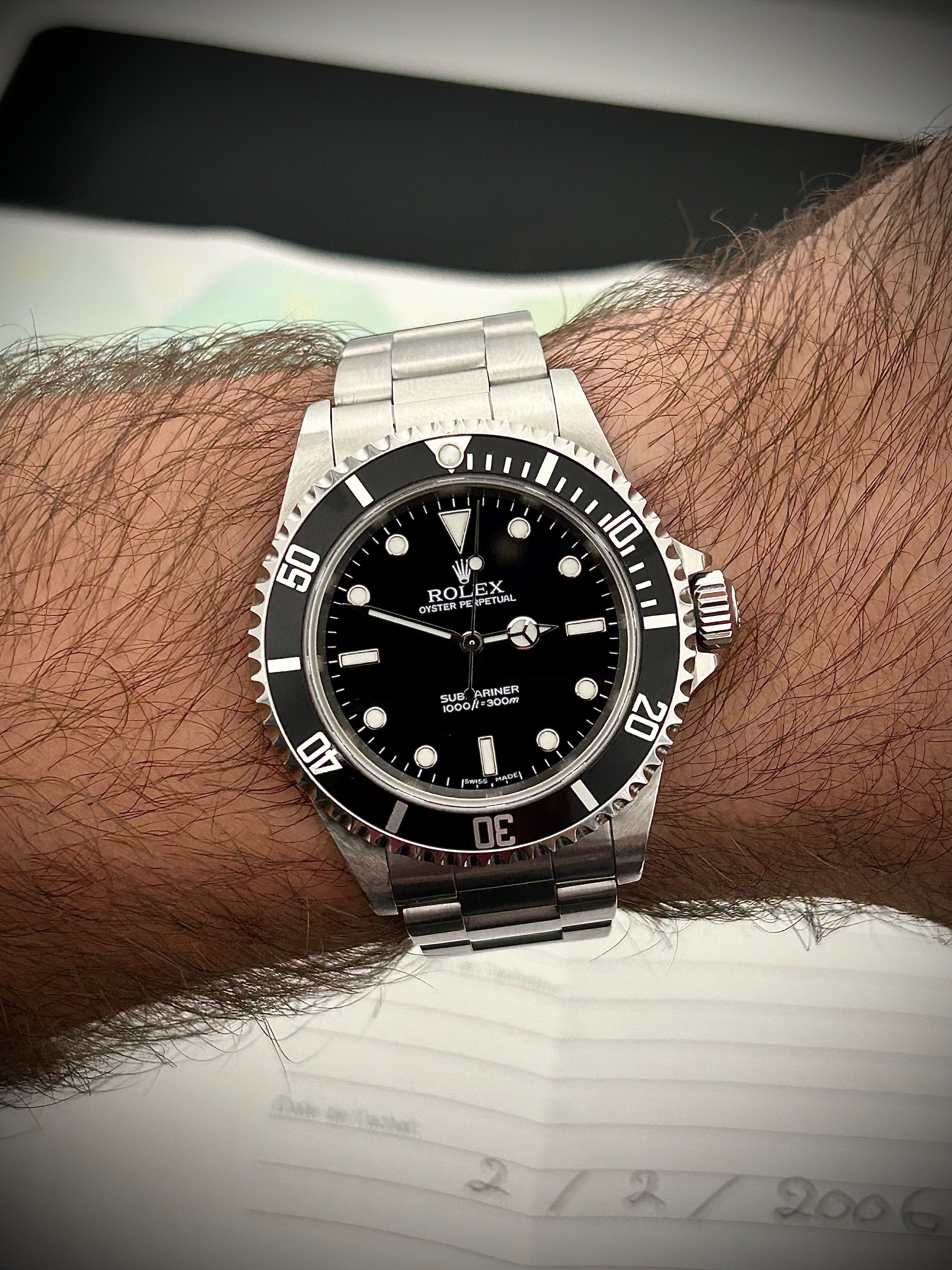2006 ROLEX SUBMARINER TWO-LINER 14060M, WATCH AND PAPERS, INC GST
