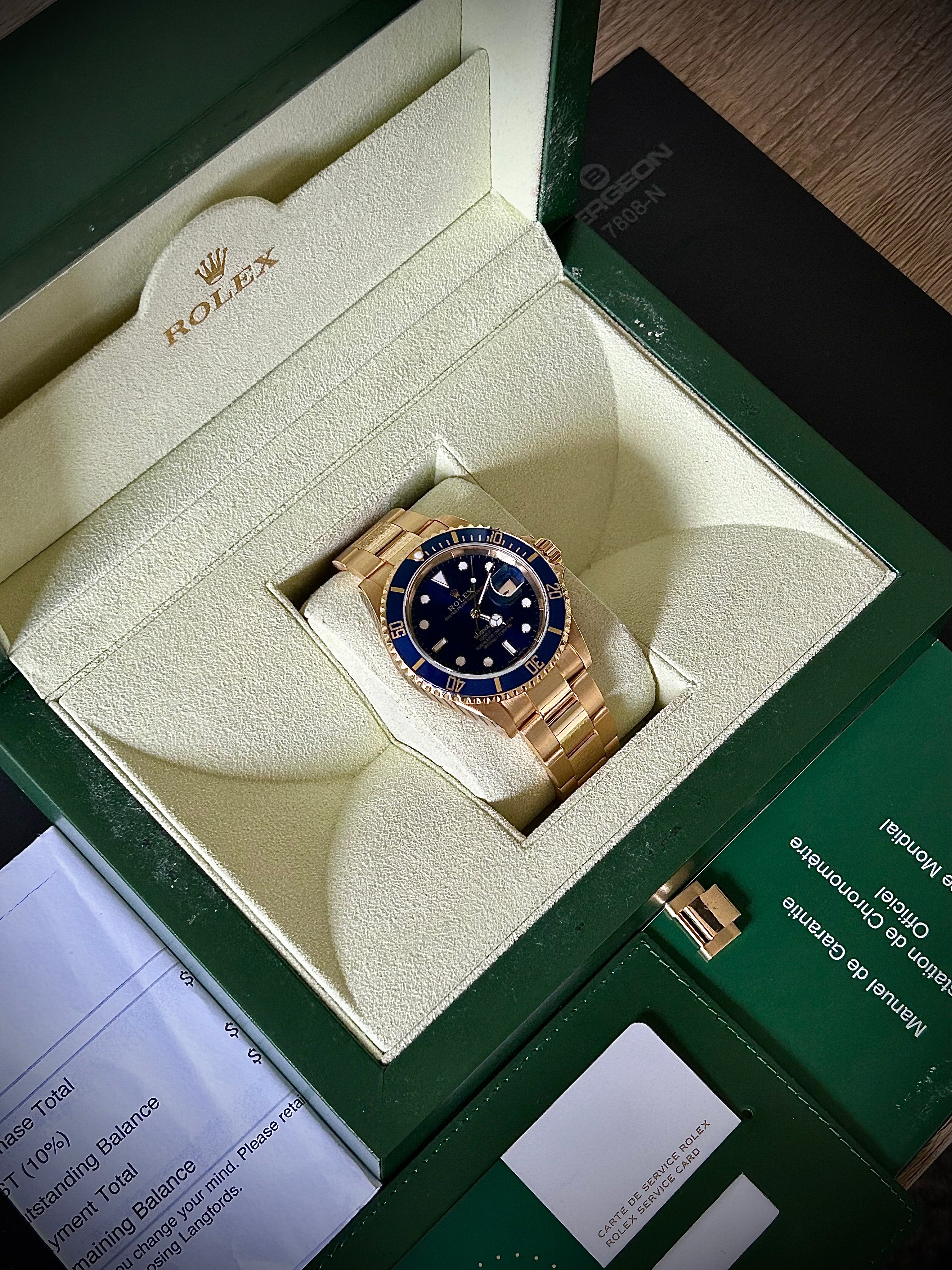 1991 ROLEX SUBMARINER DATE “BLUESY”, FULL GOLD, 16618LB, BOX AND RSC, INC GST