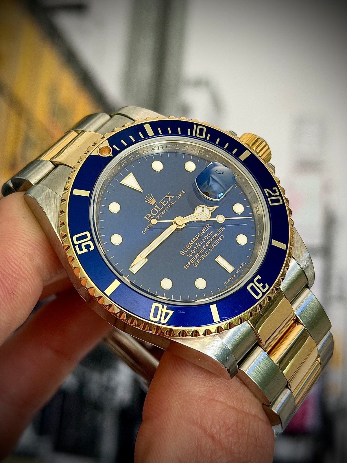 2009 ROLEX SUBMARINER DATE “BLUESY”, 16613LB, ENGRAVED REHAUT, NO HOLES CASE, SOLID END LINKS, WATCH ONLY, INC GST